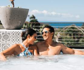 A couple relaxing in a hot tub overlooking the ocean at one of the world renowned Dana Point Hotels and Resorts 