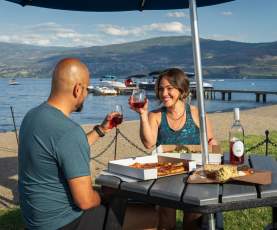 Couple with wine and food at Frind Winery picnic area