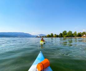 Two kayaks on Okanagan Lake with bluesky and clear water