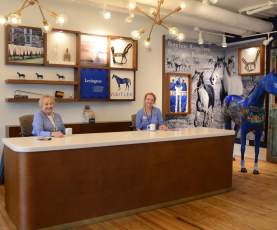 Two women sitting at a desk at the Lexington Visitors Center