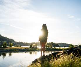 Person standing backlit in the sun on Nanaimo beach/waterfront