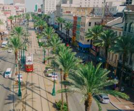 Streetcars Roll Along Canal Street - Downtown New Orleans