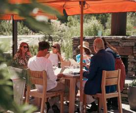 A group of friends enjoying lunch in the sun at Ayrburn
