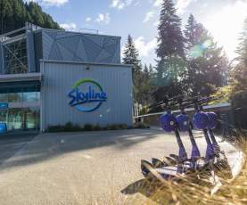 Beam electric scooters lined up out the front of the Skyline base building