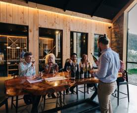A group of people attending a wine tasting at Kinross in Gibbston near Queesntown