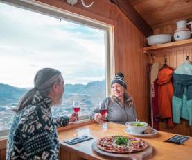 Couple enjoying pizza and wine at Heidi's Hut on Coronet Peak