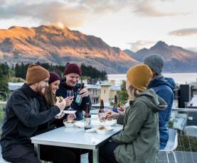 Friends enjoying cold beverages o the balcony at mi-pad