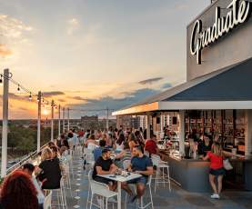 View from the Byrd House rooftop bar at Graduate Richmond with patrons mingling.