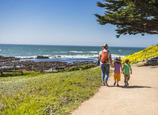 Family walking the trail at Fitzgerald Marine Reserve in San Mateo County.