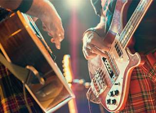 Men in kilts playing guitar