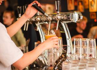 Pouring a glass of beer at a brewery in San Mateo County