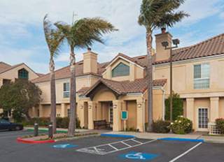 Staybridge Suites / Sonesta ES Suites San Francisco Exterior. Palm trees in parking lot.