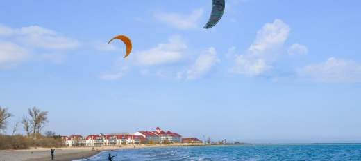 People flying kites on the beach