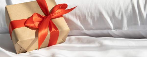Gift on bed - Shutterstock