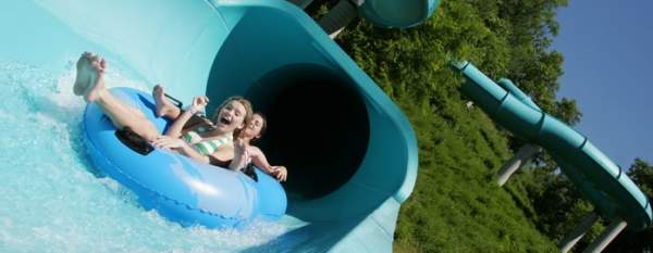 Young children on a water slide at Lake Raystown Resort's Wild River Waterpark