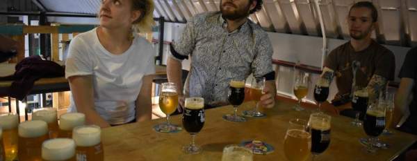 People sat around a table with beers