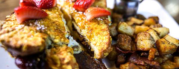 French Toast with eggs, candied bacon, ham and breakfast potatoes.