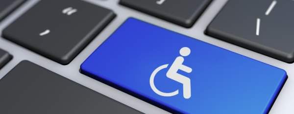 Close-up of a keyboard with a blue key featuring a wheelchair accessibility symbol.