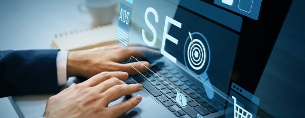 A person working on a laptop computer with the term "SEO" and other icons overlaid across the image.