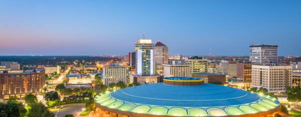 An arena in Wichita, Kansas lit up at dusk.
