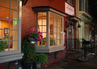 Exterior of a storefront at night on a main street that reads Elizabeth's