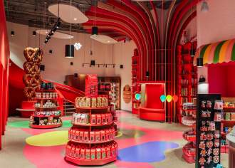 Interior of a colorful chocolate store with product stands in the middle of the room