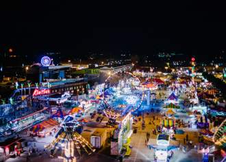 Aerial view of York State Fair at night with glowing rides