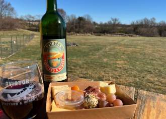 Wine poured in a glass with charcuterie