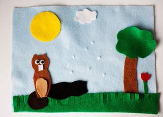 A craft of a groundhog with a tree and sun overhead