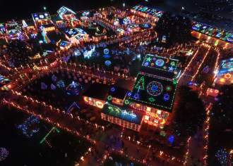 Aerial of a light display at night covering a mansion and the land surrounding it