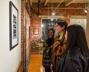 People admiring artwork at the art show.