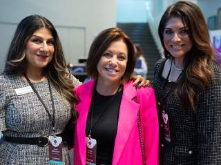 3 women professionals at conference