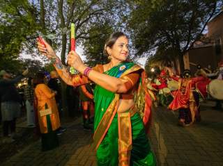 Woman dancing dressed in traditional Indian attire