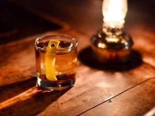 Drink with lemon slice by lantern