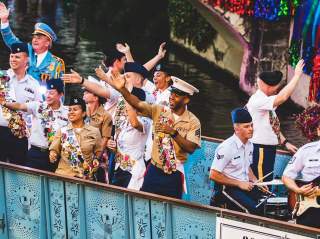 Service men and woman waving on river barge