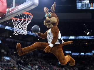 San Antonio Spurs Coyote slam dunking basketball at Spurs game