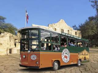 Trolley driving in front of the Alamo