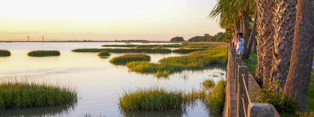 A couple takes in the sunset along the Jekyll Island Riverfront near the Jekyll Island Club Resort