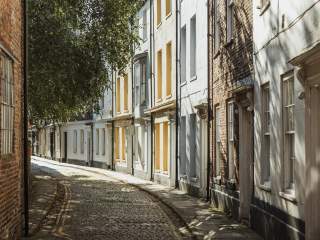 An shot from the historic Prince Street featuring colourful houses and cobbled streets.