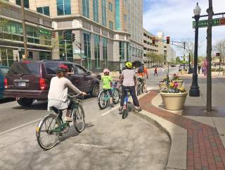 Family biking on Wayne Street downtown