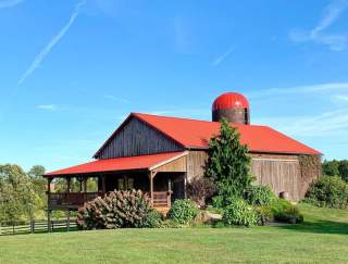 A barn with a red roof on a farm