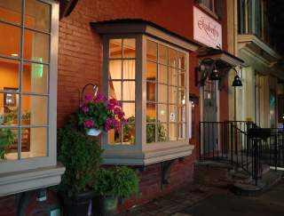 Exterior of a storefront at night on a main street that reads Elizabeth's