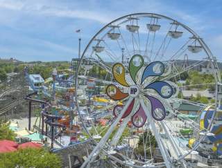 Aerial view of an amusement park with a large Ferris wheel