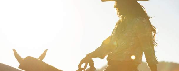 Cowgirl riding horse