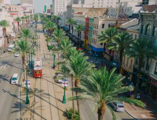 Streetcars Roll Along Canal Street - Downtown New Orleans
