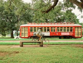 Canal Street Streetcar Passing A Biker in City Park