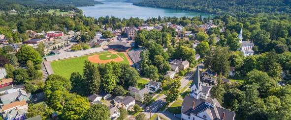 An aerial view of Cooperstown with a baseball field and lake.