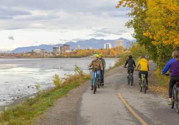 Groups of people enjoying a bike ride on the Tony Knowles Coastal Trail in Anchorage