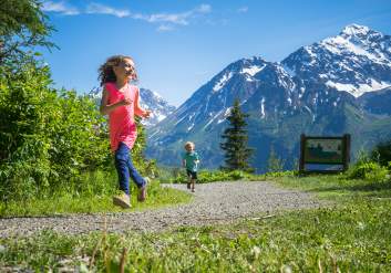 Kids run down a path at Eagle River Nature Center.