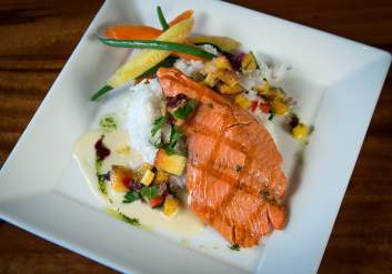 Grilled salmon plated at Haute Quarter Grill